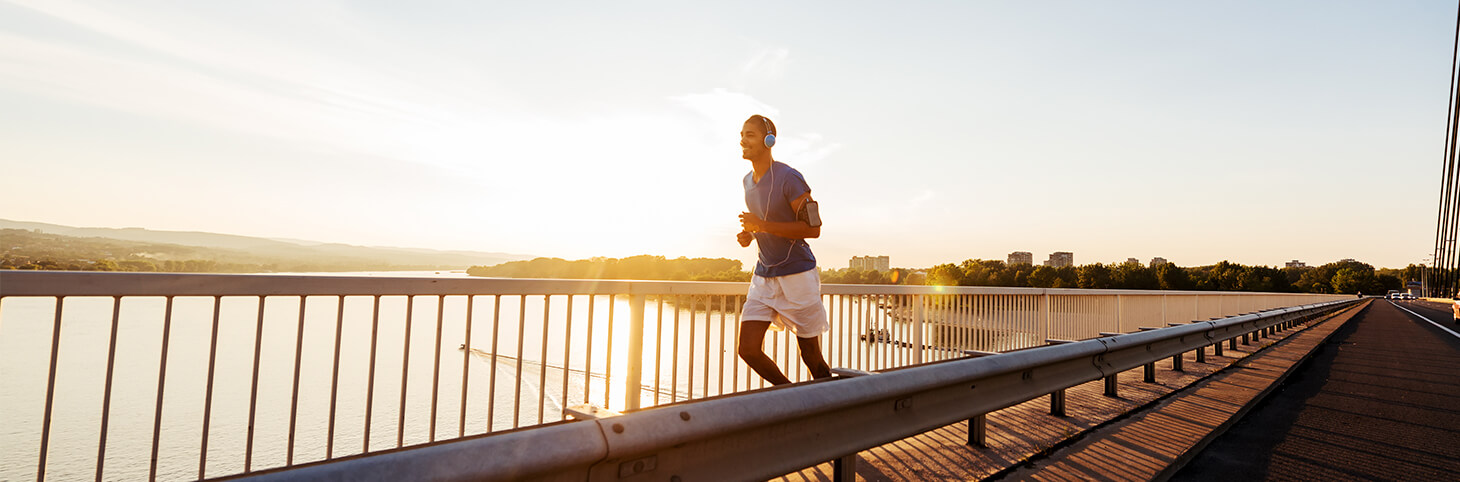 Photo of a man running with headphones on