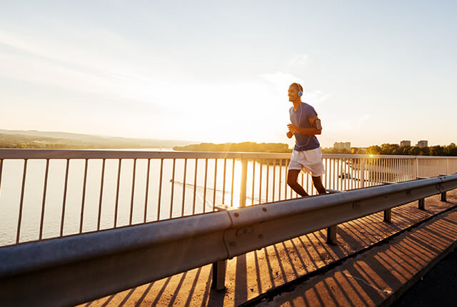 Photo of a man running with headphones on