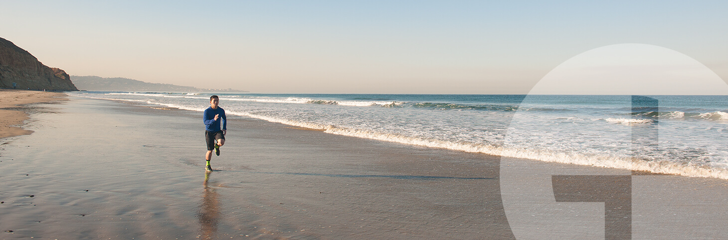 Photo of a man in athletic clothing on a beach